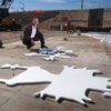 Jeffrey Rhoads, considered the godfather of public art on bridges and other infrastructure in Southern Nevada, kneels beside cutouts used to create Native American-style petroglyphs in concrete. Rhoads' work inspired the state Transportation Department to welcome such decorations on road projects. 