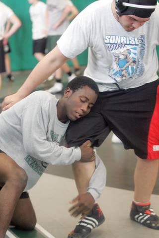 Olamide Ojo, left, and Brian Baird practice a new move during Palo Verde wrestling practice on Jan. 6.