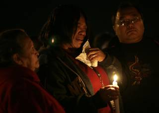 Deberah Jamerson, center, cries at the Wednesday night candlelight vigil forf Dr. Edna Almaden Makabenta in front of Makabenta's medical office on West Charleston Boulevard. The doctor was shot and killed Monday by a patient who then committed suicide by shooting himself in the mouth.