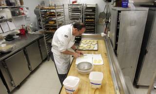 Working in the early morning, Flemming Pederson prepares basked goods at his bakery, Chef Flemming's Bake Shop.