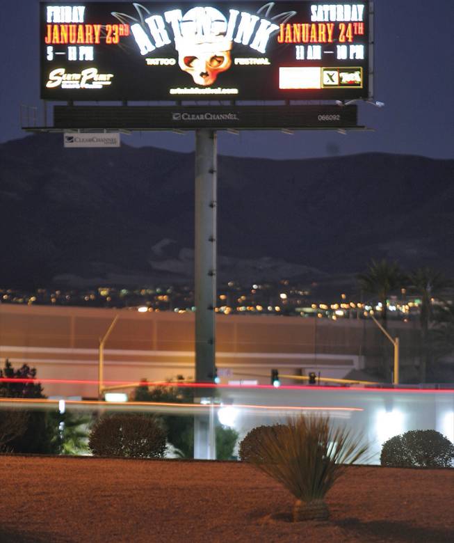 Between the exits for Warm Springs and Sunset roads, cars whiz past a digital billboard along Interstate 215.