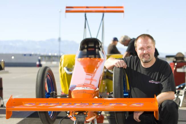 Drag racer and Boulder City resident Duane Shields poses by his top alcohol dragster during the Blast-off Open Test Session on Sunday at the Las Vegas Motor Speedway.
