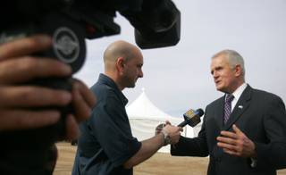 Edward Lawrence, left, of Channel 8 News interviews Gov. Jim Gibbons about renewable energy during the dedication ceremony for Sempra Energy's new El Dorado Energy Solar facility January 22. 