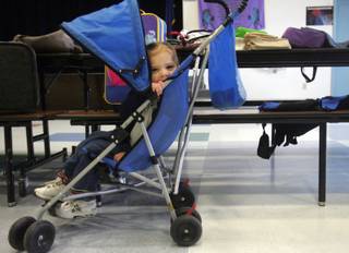 Destiny Cobian, 2, tries out a stroller at Morrow Elementary School's recycling sale Friday. Gifted and Talented Education students collect unwanted items from around the school to put on the sale. Cobian found plenty of things she would like to take home.