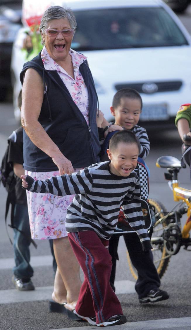 From left to right, babysitter Gloria Cohen walks Dai-Quy and Dai-Nien Tran home from school. Givens is one of nine Summerlin schools that might go from a nine-month to a year-round schedule to alleviate crowding.