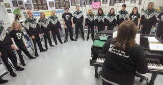 Choral teacher Lesa Rameriz leads the Vocal Infinity choral group through a song during their after-school practice at Palo Verde High School. The group practices in an arch formation to better hear one another, but performs in a mixed formation to produce a richer sound.