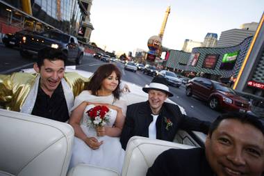 Elvis impersonator Roddy Ragsdale entertains Lynn Hassell, 46, and Neil Cawkwell, 45, of Ascot, England, as they ride back to their hotel after being married at The Little White Wedding Chapel on The Strip on Thursday, Jan. 28, 2010. Driver Oscar Oscar Villegas is at right.