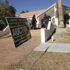 Prospective homebuyers look over a house Saturday. Auctions often offer homes that are deeply discounted but show signs of despair.