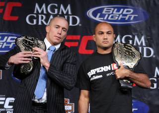 UFC welterweight champion Georges St. Pierre, left, of Montreal, Quebec, Canada and lightweight champ B.J. Penn of Hilo, Hawaii pose with their title belts during a news conference Wednesday, January 28, 2009 at MGM Grand. St-Pierre and Penn headline Saturday night's UFC 94 card in a rematch of their first fight, which St. Pierre won by split decision three years ago. While both fighters could likely make the UFC Hall of Fame one day, a win by Penn would make him the first UFC fighter to hold two titles in two different weight classes at the same time.