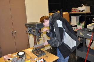 Evan Liebhauser drills holes in a bracket for the FIRST robotics program robot at Boulder City High School.