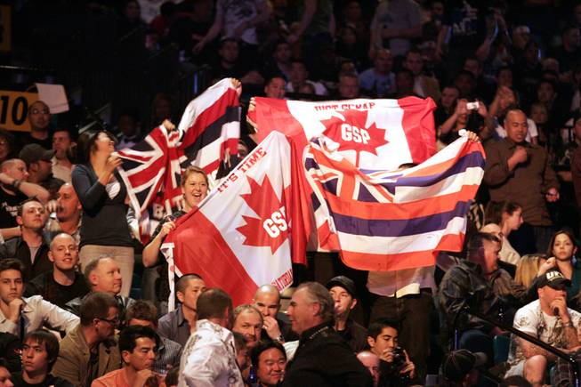 Georges St. Pierre fans, as well as B.J. Penn fans show their support for their respective fighters by waving Canadian and Hawaiian flags Saturday night at the MGM Grand before the pair's superfight at UFC 94.
