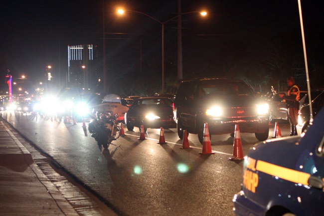 A line of cars waits to go through the DUI checkpoint on the corner of Flamingo and Lindell roads. The checkpoint was setup Sunday to nab intoxicated drivers after the Super Bowl.
