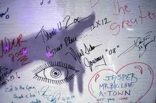 Zoe Thrall, studio director, points out musician signatures on a wall at the Studio at the Palms Thursday, Jan. 15, 2009.  