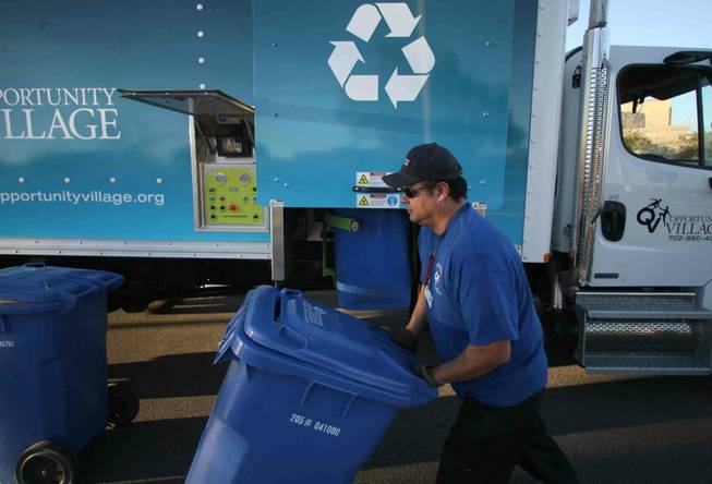Wallie Luna of Opportunity Village prepares to shred paper Tuesday during a document shredding event hosted by the non-profit and the Metropolitan Police Department in the parking lot of the Northwest Area Command. 
