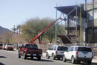 With the street lined with cars, the expansion of the Henderson Justice Facility continues on Basic Road Tuesday.