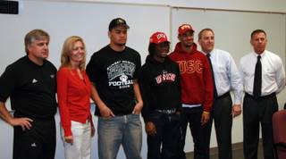 (From left) Palo Verde football coach Darwin Rost, athletic department secretary Barbara McGill, Liloa Nobriga, Sidney Hodge, Torin Harris, principal Dan Phillips and athletic department advisor Bill Kreaines pose for photos during the Panthers' National Signing Day event.