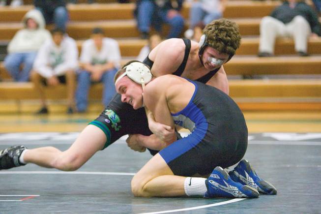Basic wrestler Daniel Maman, left, grapples with Green Valley's Chris Fehlman at a meet with Basic, Green Valley and Libertyon Jan. 28.
