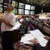 Derwood Haines of Michigan looks over a board of Super Bowl XLIV bets at the Las Vegas Hilton sports book Thursday, Feb. 4, 2010.