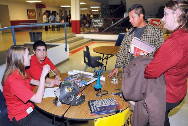 Southeast Career and Technical Academy students Shannon Miller, left, and Daniel Montes answer questions regarding the field of construction to Saul and Elizabeth Valdez during an open house at the school Feb. 5. The Montes' son is interested in the field and is considering applying for the technical school, which is one of the largest high school construction programs in the area.