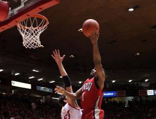 Wink Adams lays it in over a New Mexico defender Saturday as UNLV took on the New Mexico Lobos Saturday in Albuquerque New Mexico at the Pit. The Lobos defeated the Rebels 73-69 in overtime; it was the second straight game UNLV has lost in overtime.