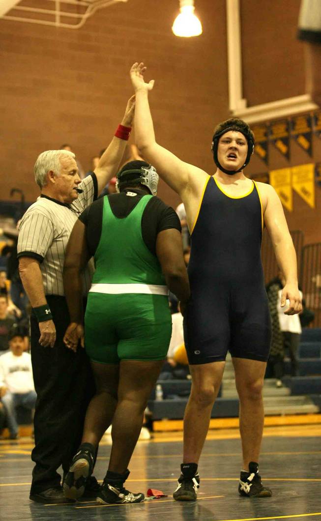 The referee raises the hand of Boulder City High wrestler Kyle Erickson, right, after he defeated Virgin Valley's D'Andre Matthews in the 3A Southern League wrestling tournament in Boulder City High Saturday.
