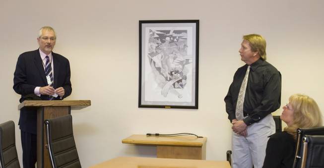 St. Rose Dominican Hospitals President Val Baciarelli, left, introduces David Donovan and his art work, "Nevada Tales," at ceremony Friday.