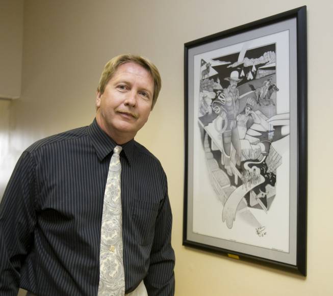 David Donovan poses by his painting, "Nevada Tales," after a presentation ceremony Friday at St. Rose Dominican Hospital-de Lima Campus.