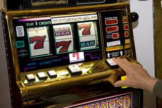 Gene Gabaldon puts a few dollars on a Megabucks machine at the South Point Casino on Friday, Feb. 13, 2009. 