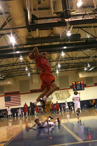 Findlay Prep's Avery Bradley (11) slam dunks during a game at Bishop Gorman High in February.