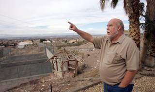 Bill Wilson, a resident of the Section 4 neighborhood in Henderson, points to where NV Energy's proposed large transmission lines would run through his yard.