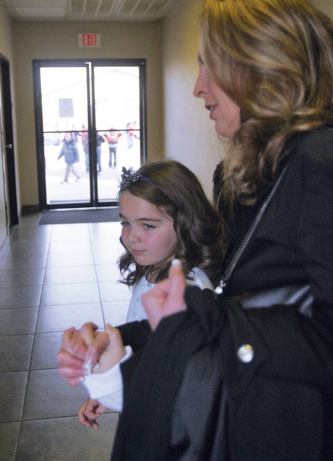 Green Valley Christian Academy student Nadia Voelkening and her mother, Michele, make their way through the halls of Mountain View Christian School to the classroom where Nadia will compete in the Association of Christian Schools speech competition.