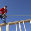 Habitat for Humanity volunteer Rodney Stephens balances himself on a the frame of a wall while working on a home being built for Rosa Santana on London Porter Court Saturday morning by Habitat for Humanity Las Vegas, the Greater Las Vegas Association of Realtors and Citibank.