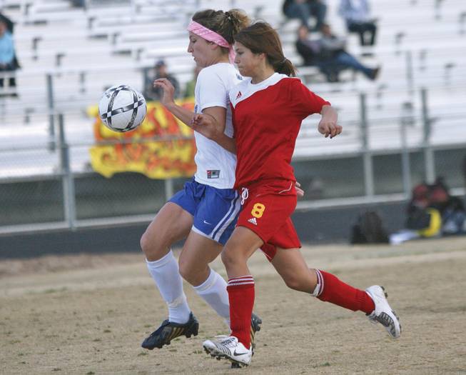 Southeast Career Technical Academy's Rachel Montoya (8), right, battles for the ball with a Basic defender during a game on Feb. 12.
