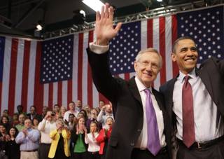Senate Majority Leader Harry Reid, left, and President Barack Obama wave as they conclude a town hall meeting Friday, Feb. 19, at Green Valley High School in Henderson.