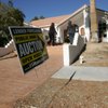Prospective bidders inspect a house last month that was slated to be a auctioned off in a large auction of foreclosed homes.