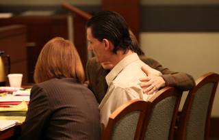 Defense attorneys Amy Coffee, right, and Stacey Roundtree quiet Chester A. Stiles after an outburst Friday. He became visibly upset for the first time since his trial started when excerpts from letters he wrote to former girlfriend Susan Windrem were read aloud.