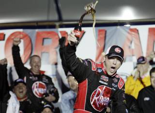 Kevin Harvick celebrates after winning the NASCAR Nationwide Series Sam's Town 300 auto race at the Las Vegas Motor Speedway on Saturday, Feb. 27, 2010.