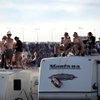 Fans watch while on top of their RVs in the infield at the Shelby 427 Sprint Cup Race at the Las Vegas Motor Speedway on Sunday.