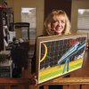 Richann Bender, executive director of California-Nevada Super Speed Train Commission, holds an illustration from a 1983 Las Vegas Sun feature on the California-Nevada high-speed train Monday in her home office. The economic stimulus bill contains money for such projects.