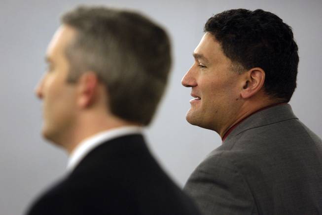 Deputy public defender Norman Reed, right, speaks to the judge during the arraignment of Harold Montague, accused of an assault with a medieval-style battle ax that killed a baby, at the Regional Justice Center, Wednesday, March 3, 2010. Prosecutor Giancarlo Pesci stands at left.