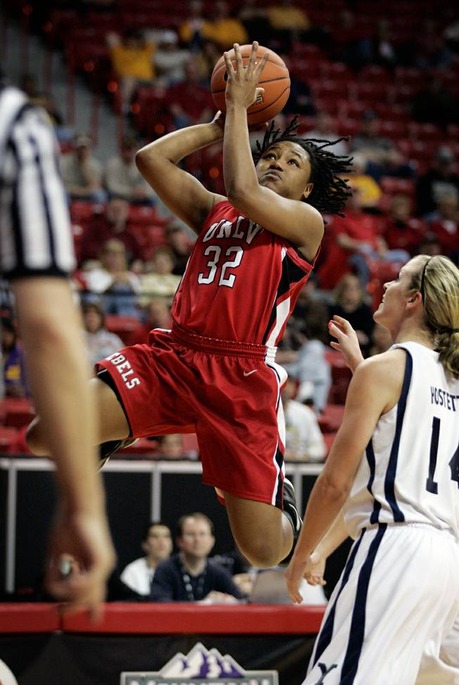 India Chaney, left, of UNLV shoots a layup past Sarah Red-Hostetter of BYU during the first round of the Mountain West Championship at the Thomas & Mack Center in Las Vegas on Tuesday. UNLV won the game 66-58.