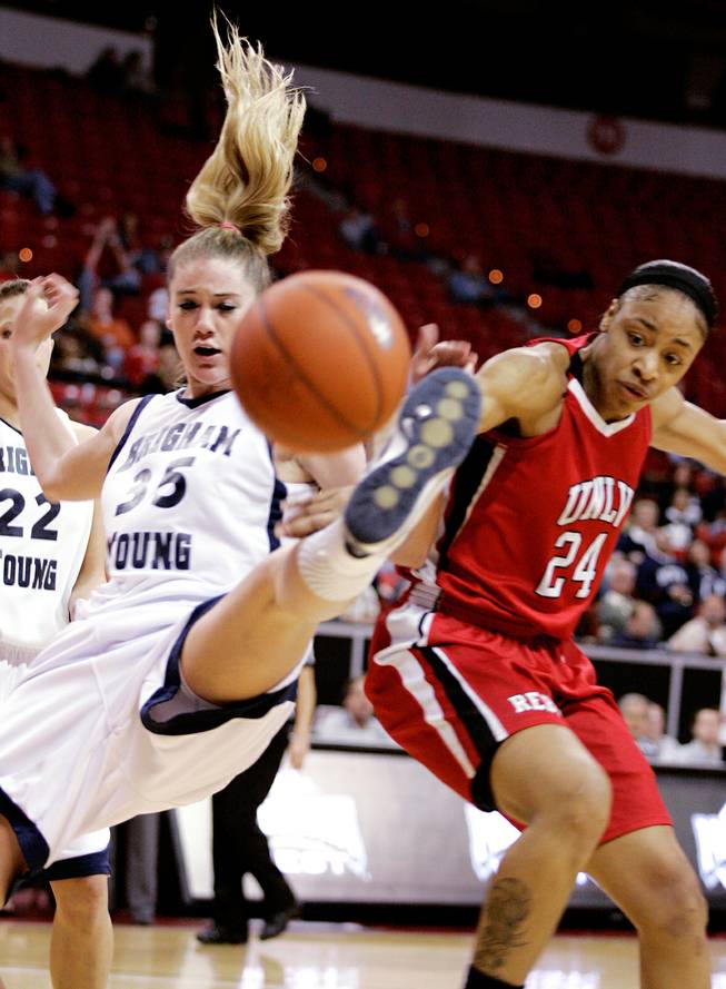 Shamela Hampton, right, of UNLV and Kristen Riley of BYU try to catch a rebound during the first round of the Mountain West Championship at the Thomas & Mack Center in Las Vegas on Tuesday. UNLV won the game 66-58.