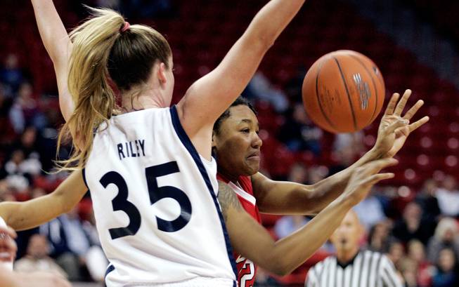 India Chaney, right, of UNLV makes a pass past Kristen Riley of BYU during the first round of the Mountain West Championship at the Thomas & Mack Center in Las Vegas on Tuesday. UNLV won the game 66-58. 