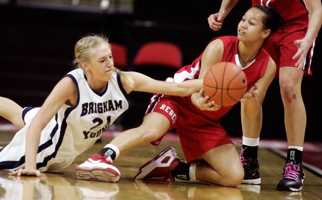 Erica Helms, right, of UNLV and Stephanie Buhler of BYU fight for a loose ball during the first round of the Mountain West Championship at the Thomas & Mack Center in Las Vegas on Tuesday. UNLV won the game 66-58. 