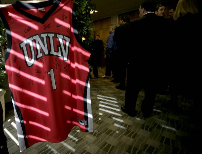 A Wink Adams jersey signed by UNLV players hangs at the memorial service of Corey Fields on Tuesday at Palm Mortuary.   Rebels coach Lon Kruger presented the jersey to the Fields family.