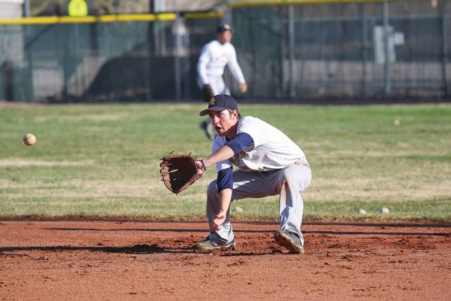 Boulder City's shortstop Adam Eudy catches a grounder during infield practice.