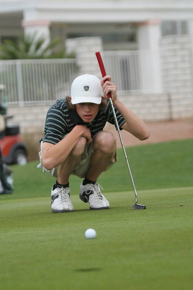 Green Valley High junior Ryan Green lines up a putt on the third hole during varsity practice at Legacy Golf Club.
