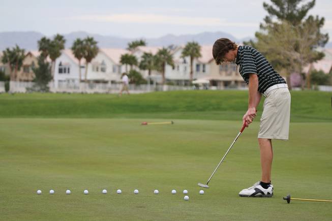 Green Valley junior Ryan Green practices on the putting green at Legacy Golf Club.
