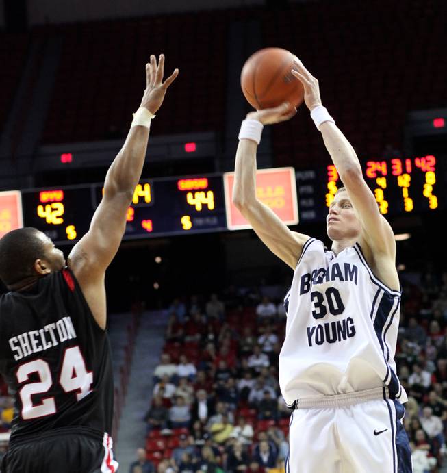 Lee Cummard shoots a three over Tim Shelton as BYU takes on San Diego State at the Thomas & Mack Center in the semifinals of the Mountain West Tournament.  The Aztecs beat the Cougars 64-62.