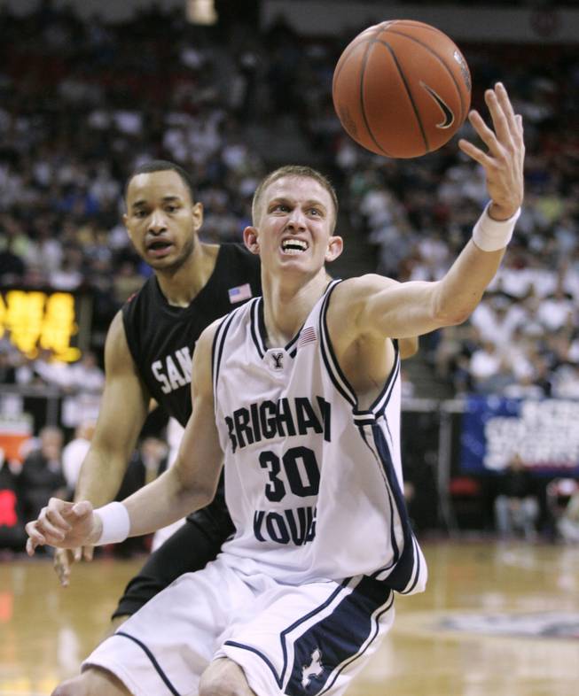 BYU guard Lee Cummard grabs a loose ball in front of San Diego State forward Lorenzo Wade during a semifinal game of the Mountain West Conference tournament on Friday, March 13, 2009, at the Thomas & Mack Center.